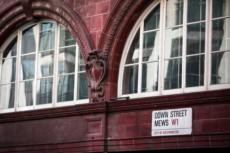 Two windows surrounded by red brick