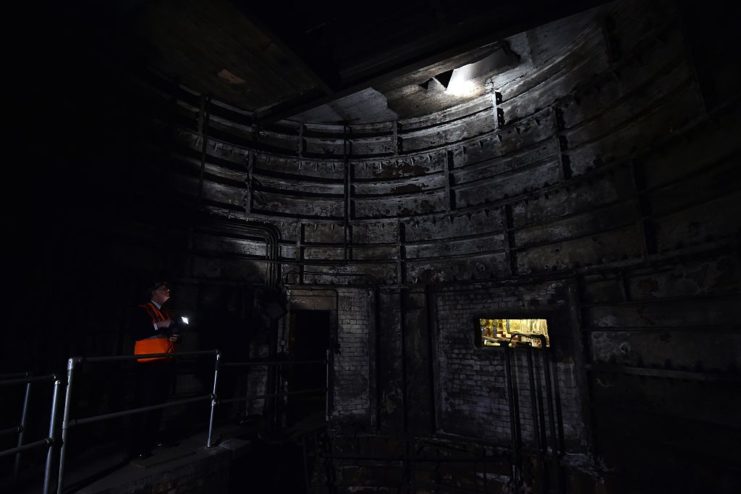 Dark tunnel barely lit by a single lightbulb