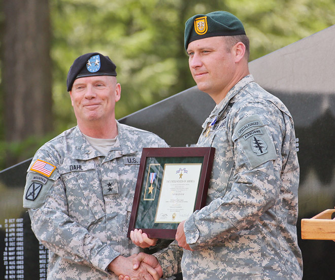 Kenneth R. Dahl presenting Earl Plumlee with the Silver Star