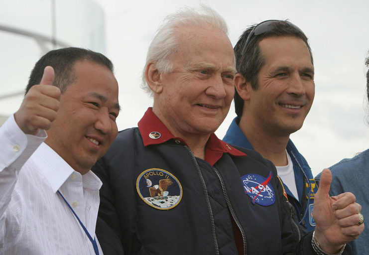 John Herrington standing with Buzz Aldrin and David Jin