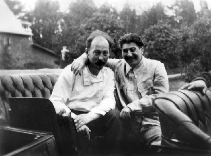 Stalin sitting with his arm around Felix Edmundovich Dzerzhinsky
