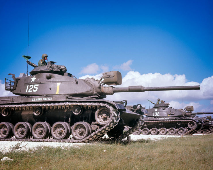 Three M48A3 Patton tanks driving forward in a line