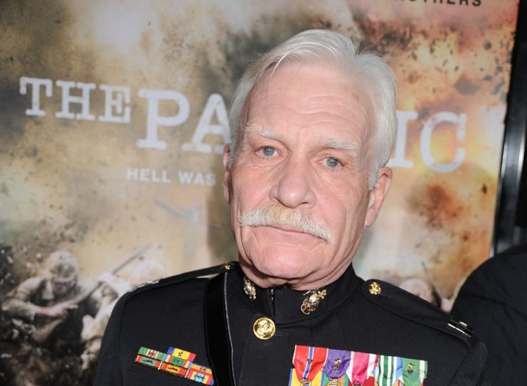 Dale Dye standing on a red carpet