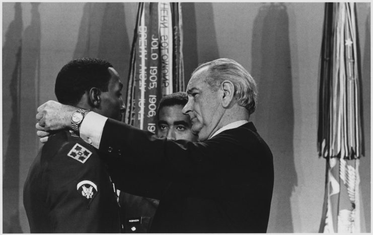 President Lyndon B. Johnson placing the Medal of Honor around Dwight H. Johnson's neck