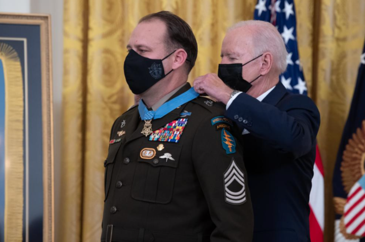 Joe Biden placing the Medal of Honor around Earl Plumlee's neck