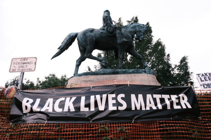 Black Lives Matter banner beneath the statue of Robert E. Lee atop a horse