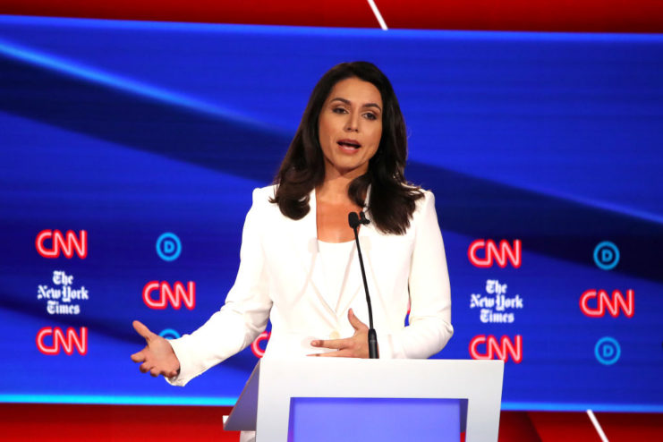 Tulsi Gabbard speaking at a podium