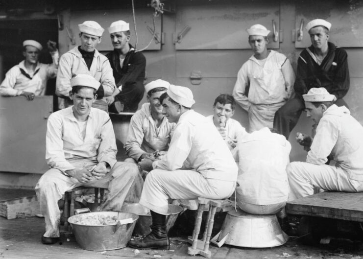 US Navy sailors peeling potatoes on the deck of the USS Arkansas (BB-33)