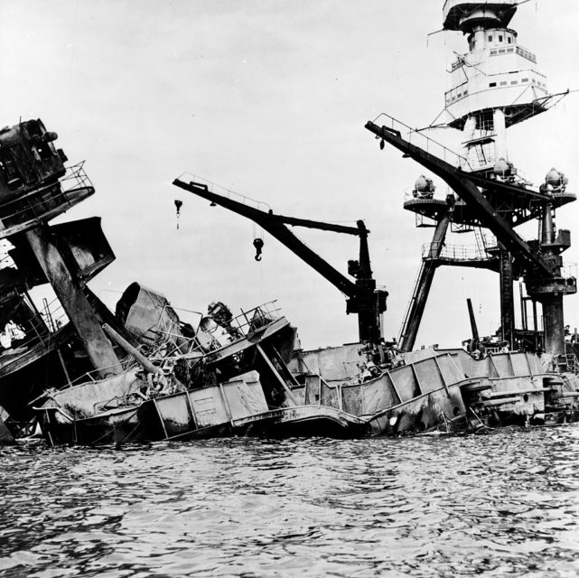 Wreckage of the USS Arizona half-submerged in the water