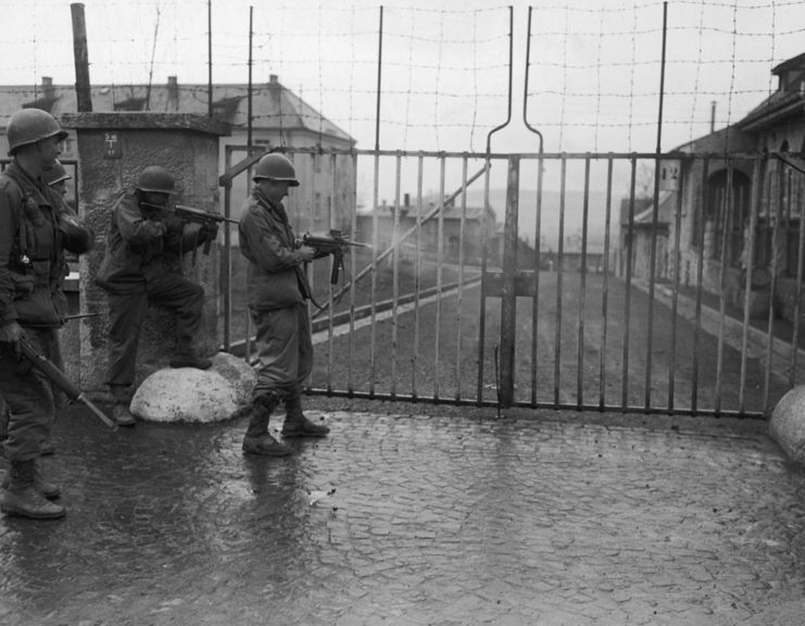 German infantrymen standing at the gates of a German prison camp