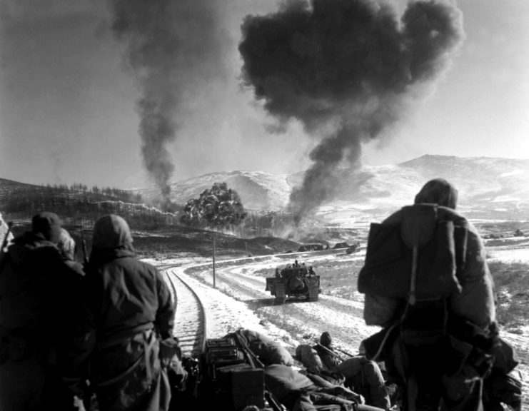 Marines looking at a smoke cloud in the distance