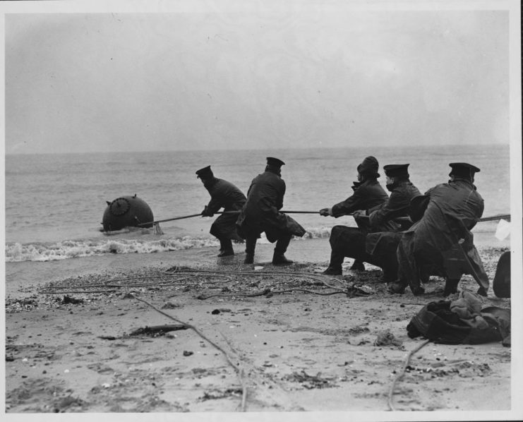 Bomb disposal experts pulling a sea mine out of the ocean