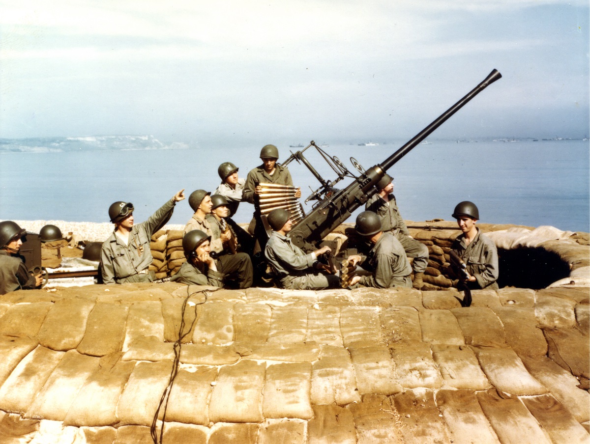 An anti-aricraft gun crew man a Bofors 40mm gun from behind sandbags at a coastal emplacement, England, 1944. (Photo by PhotoQuest/Getty Images)