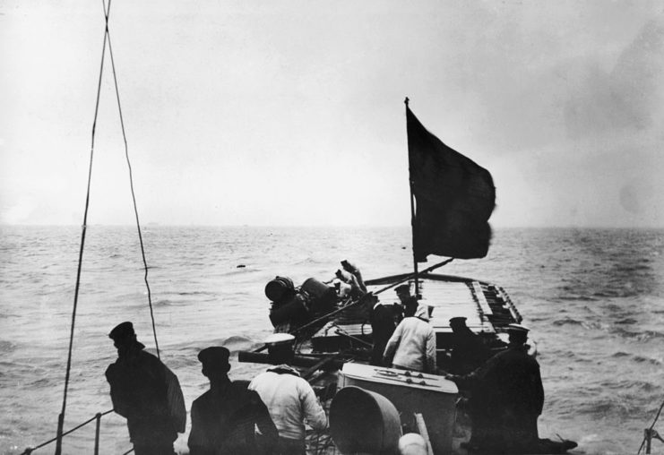 British naval personnel aboard a small boat at sea