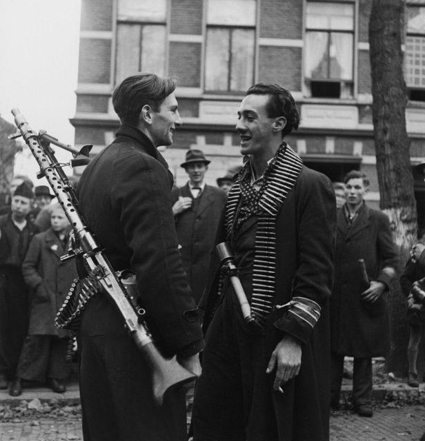 Armed Dutch resistance fighters speaking to each other
