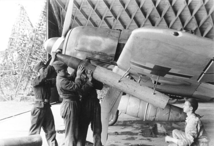 Airmen loading a Werfer-Granate 21 into the underwing pod of a Focke-Wulf Fw 190 A-8 'Sturmböcke'