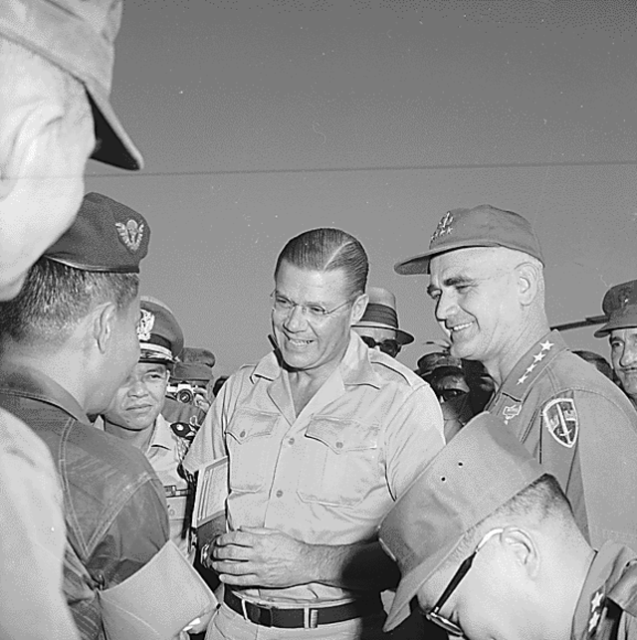 Robert McNamara standing with General Westmoreland