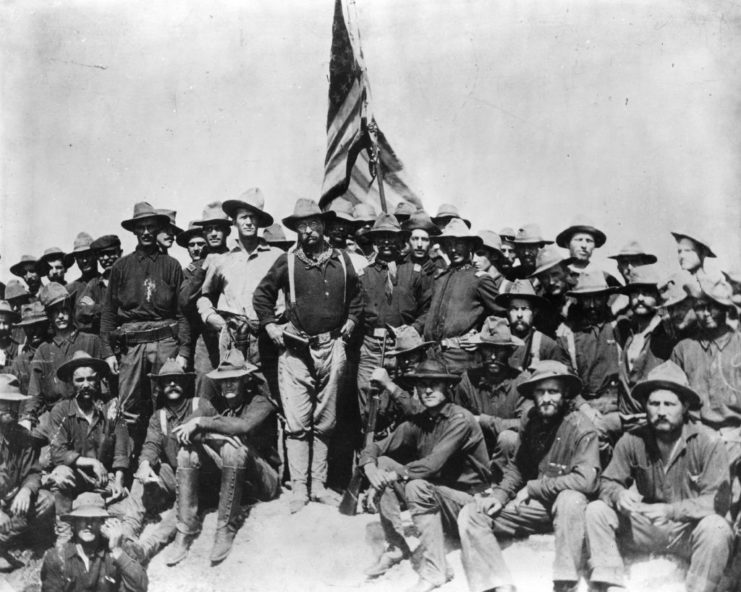 Theodore Roosevelt standing with the Rough Riders