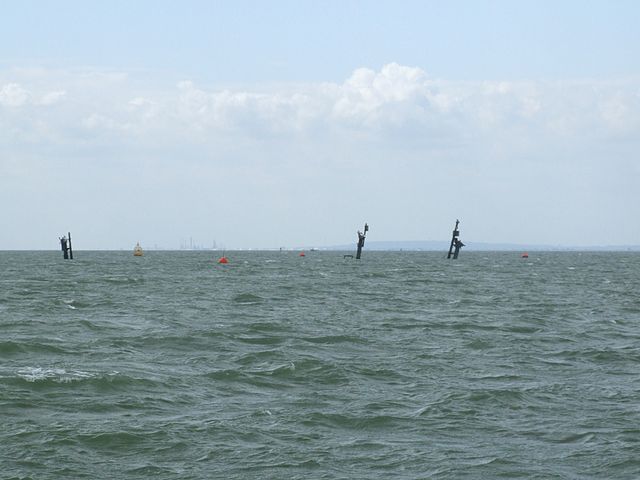 The masts of the sunken SS Richard Montgomery in the distance
