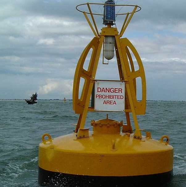 Yellow buoy with a warning sign attached to it