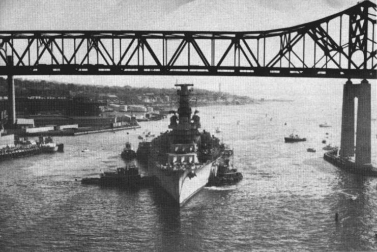 USS Massachusetts (BB-59) being towed under a bridge