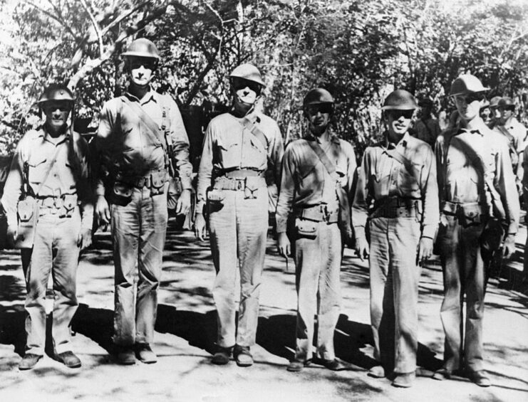 Six members of the 4th Marine Regiment standing in the jungle