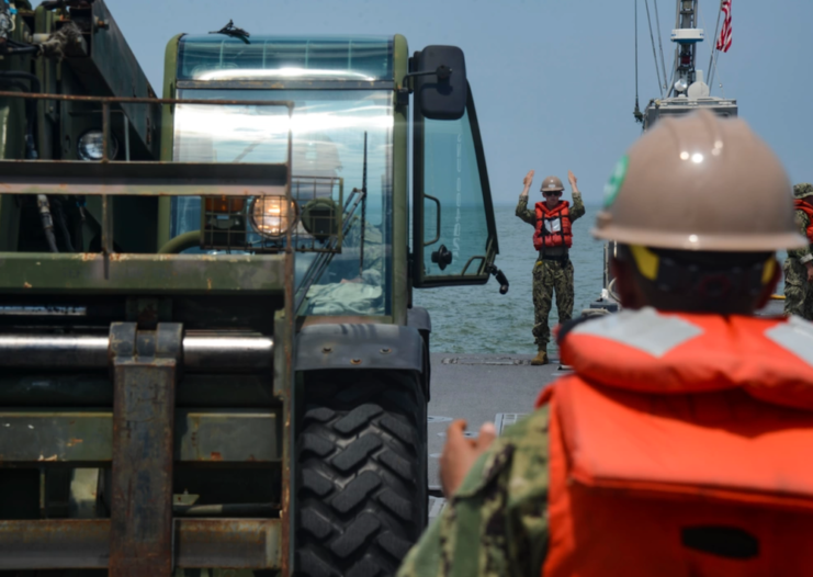 ACB 2 members surrounded by construction equipment