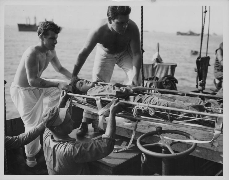 An Injured Marine is loaded onto a Coast Guard ship