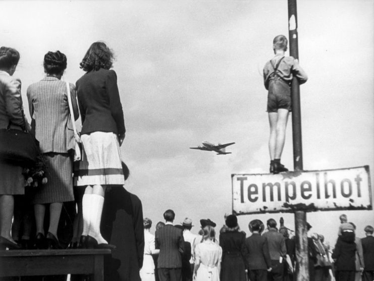 Berlin residents watching supply planes flying in the air