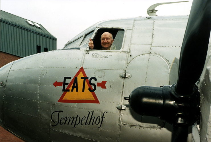 Gail S. Halvorsen giving a thumbs up from the cockpit of a plane