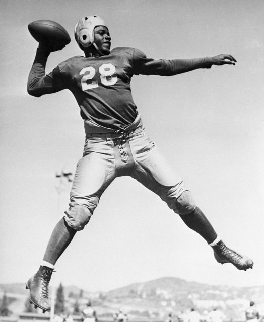 Jackie Robinson preparing to throw a football