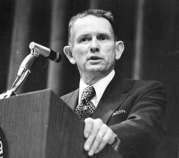 John Singlaub standing at a podium