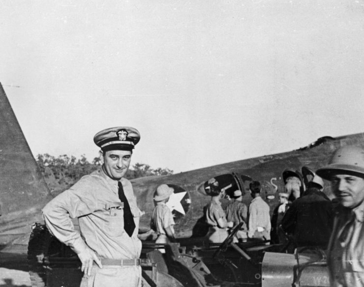 Lyndon B. Johnson standing with other men near an aircraft