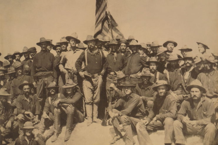 Teddy Roosevelt and the Rough Riders stand at the top of San Juan Hill 
