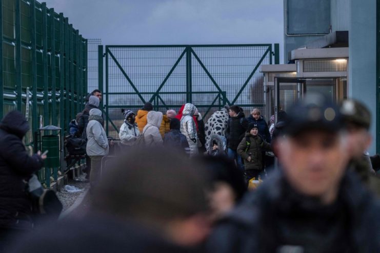 Ukrainian citizens lined up at the pedestrian crossing into eastern Poland