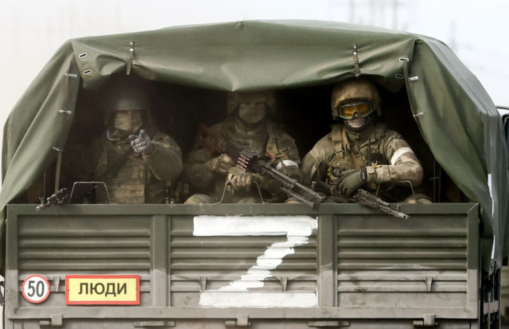Russian troops in the back of a military vehicle