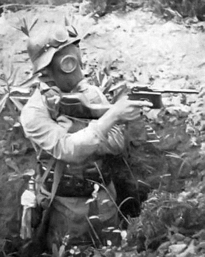 Chinese soldier wearing a gas mask and holding a Shansi Type 17