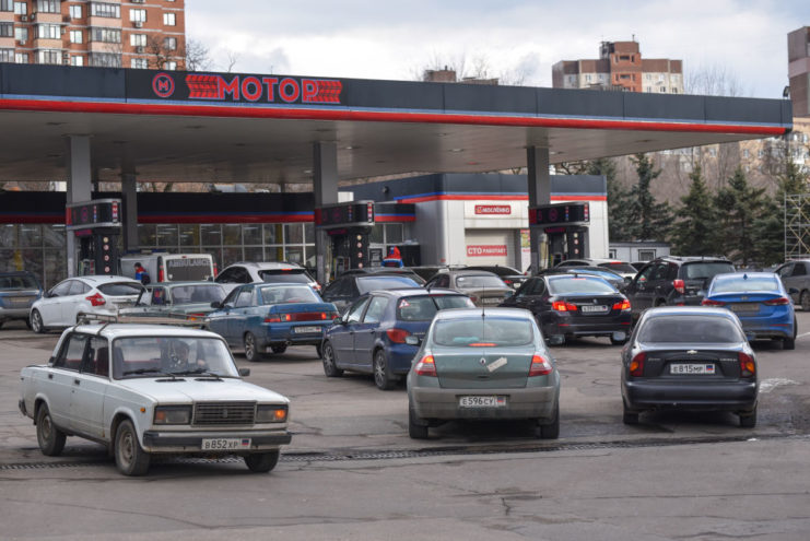 Cars lined up at a gas station