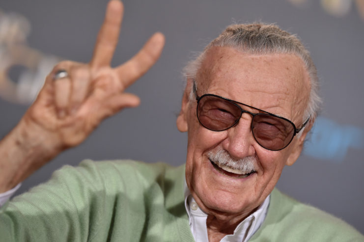 Stan Lee gives peace sign at movie premiere
