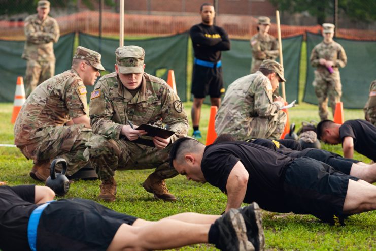 Staff Sgt. Gabriel Wright grading soldiers doing pushups