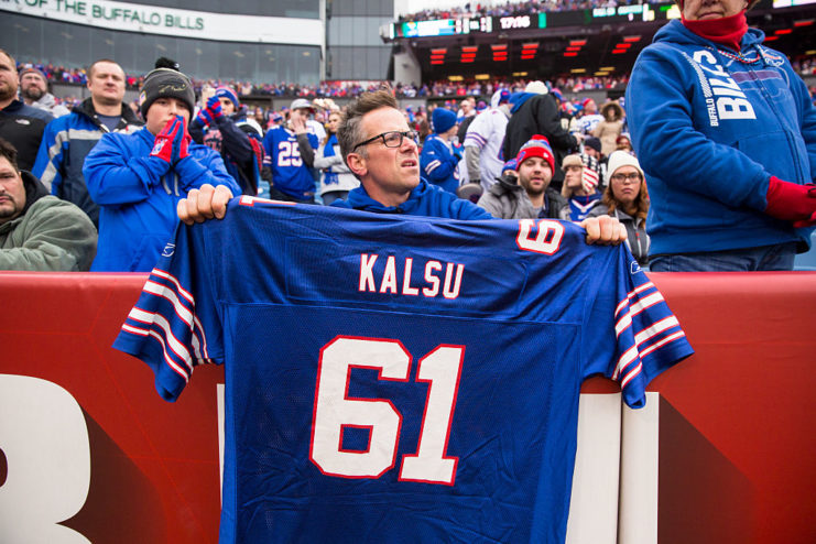Fan holding up Bob Kalsu's jersey