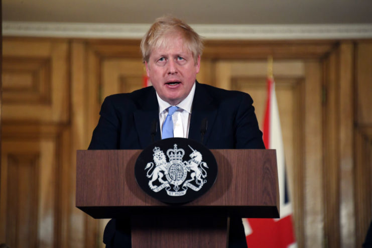 Boris Johnson speaking at a podium