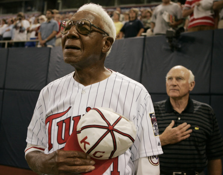 Buck O'Neil standing for the National Anthem