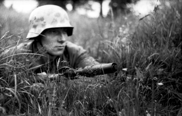A German soldier, armed with a Mauser Karabiner 98k, lying in the grass