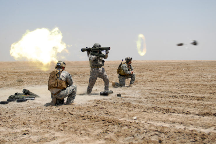 Three US Army Special Forces soldiers firing a Carl Gustaf 84 mm recoilless rifle