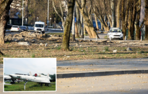 Police tape surrounding a crater in the earth + Tupolev Tu-141 on display