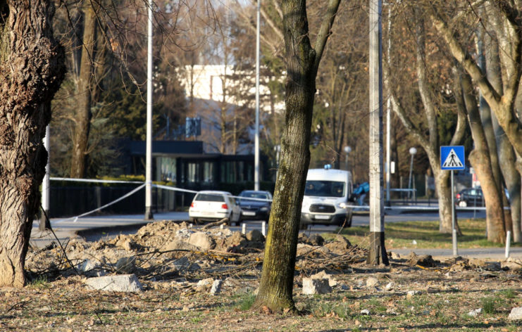 Police tape surrounding a crater in the earth