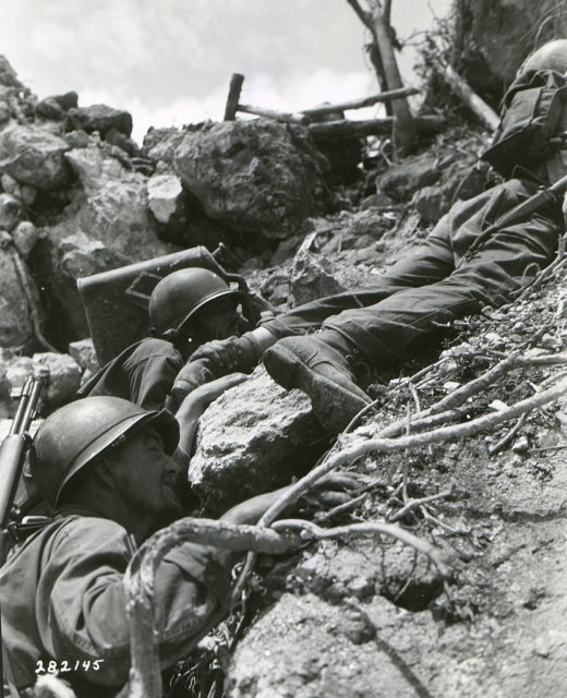 Marines climbing up a steep slope