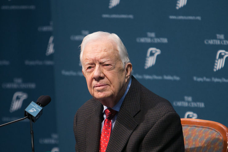 Jimmy Carter sitting before a microphone