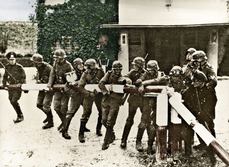 German soldiers removing a border barrier